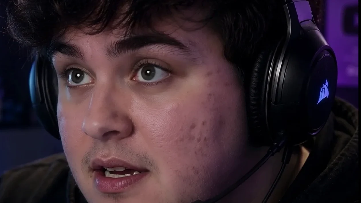 The same streamer after a restrained VanityFilter pass, with skin calmed down while hair, eyes, stubble, and the headset stay sharp